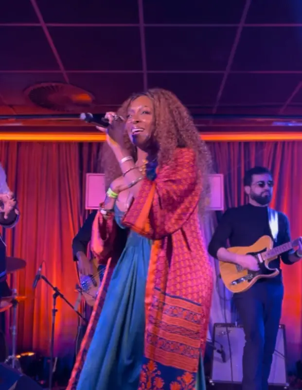Kandace Lindsey performing on stage in a red and blue robe